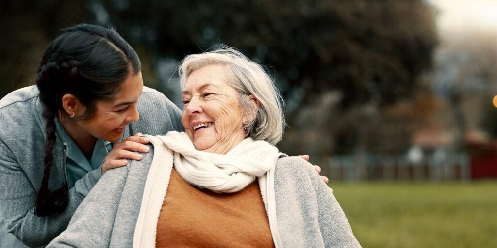 caregiver-helping-woman-with-disability-in-park-for-support-trust-and-care-in-retirement